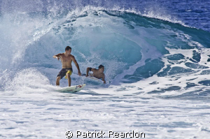 A crowded wave at Pipeline, North Shore, Oahu. by Patrick Reardon 